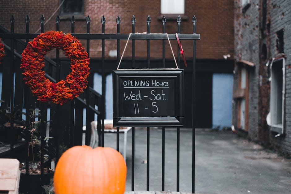 Opening hours sign on a fence representing accessibility information